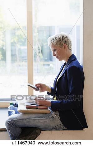 Woman using cell phone on lunch break View Large Photo Image Stock Image - Woman using cell phone on lunch break. Fotosearch