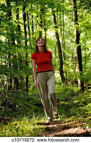 Woman walking in forest View Large Photo Image Stock Image - Woman walking in forest. Fotosearch