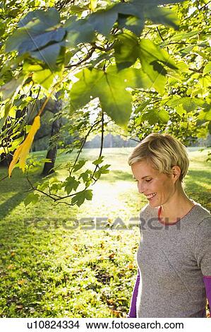 Woman walking in park View Large Photo Image Picture - Woman walking in park. Fotosearch