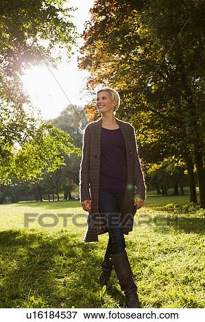 Woman walking in park View Large Photo Image Stock Photo - Woman walking in park. Fotosearch