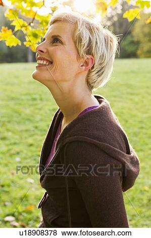 Stock Photo - Woman walking in park. Fotosearch