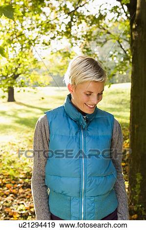 Stock Photo - Woman walking in park. Fotosearch