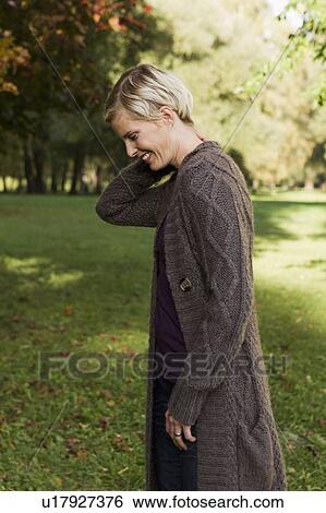 Woman walking in park View Large Photo Image Stock Photograph - Woman walking in park. Fotosearch