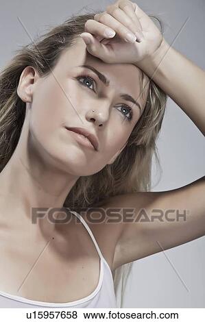 Woman wiping her forehead View Large Photo Image Stock Photo - Woman wiping her forehead. Fotosearch