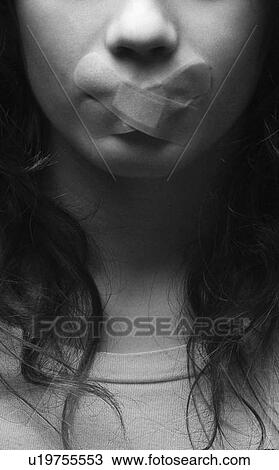 Stock Image - Woman with bandage over mouth. Fotosearch