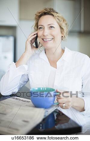 Woman with coffee talking on phone View Large Photo Image Stock Photograph - Woman with coffee talking on phone. Fotosearch