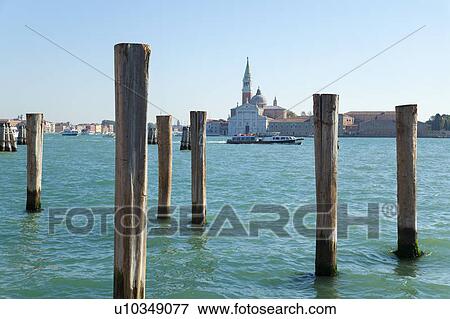 Wooden posts in urban harbor View Large Photo Image Stock Photo - Wooden posts in urban harbor. Fotosearch