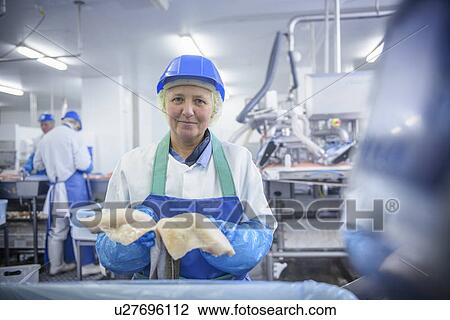 Worker cleaning fish in factory View Large Photo Image Stock Image - Worker cleaning fish in factory. Fotosearch