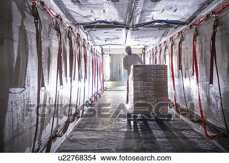 Worker pushing cart in factory View Large Photo Image Picture - Worker pushing cart in factory. Fotosearch
