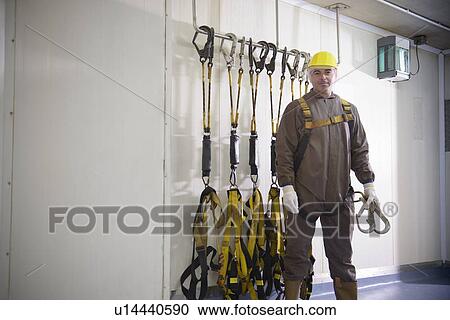 Worker standing in factory View Large Photo Image Stock Image - Worker standing in factory. Fotosearch