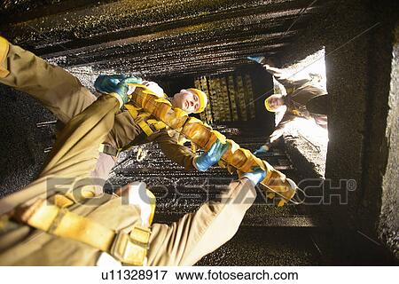 Workers smoking fish filets in factory View Large Photo Image Stock Photo - Workers smoking fish filets in factory. Fotosearch