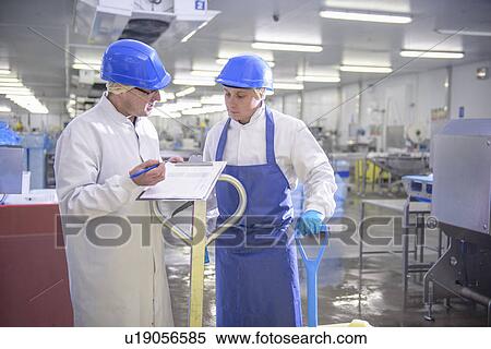 Workers talking in factory View Large Photo Image Stock Photography - Workers talking in factory. Fotosearch
