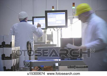 Picture - Workers weighing product in factory. Fotosearch