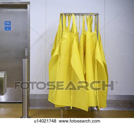 Yellow aprons on drying rack View Large Photo Image Stock Photo - Yellow aprons on drying rack. Fotosearch