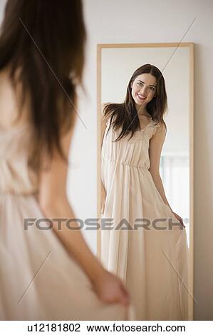 Stock Image - Bride trying on wedding dress. Fotosearch