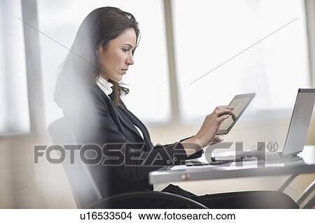 Businesswoman using tablet pc View Large Photo Image Picture - Businesswoman using tablet pc. Fotosearch