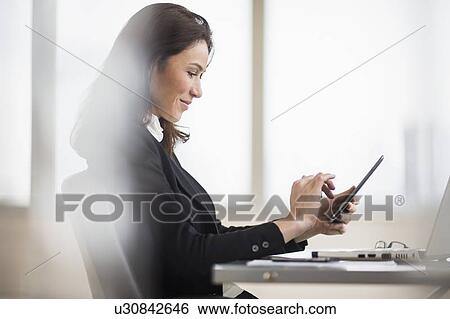 Businesswoman using tablet pc View Large Photo Image Stock Photograph - Businesswoman using tablet pc. Fotosearch
