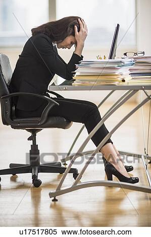 Stock Photography - Businesswoman with head in hands. Fotosearch