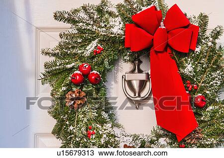 Christmas wreath hanging on door View Large Photo Image Stock Image - Christmas wreath hanging on door. Fotosearch