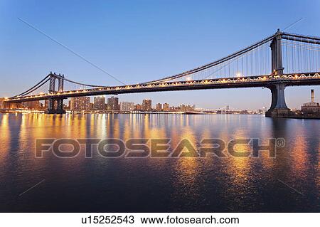 Cityscape with bridge lights reflected in water View Large Photo Image Stock Image - Cityscape with bridge lights reflected in water. Fotosearch