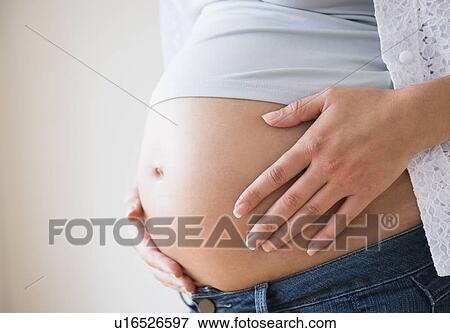 Stock Photo - Close-up of pregnant woman's belly. Fotosearch