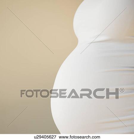 Close-up of pregnant woman's belly View Large Photo Image Stock Photo - Close-up of pregnant woman's belly. Fotosearch