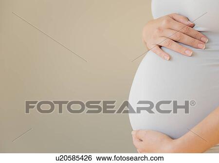 Stock Photograph - Close-up of pregnant woman's belly. Fotosearch