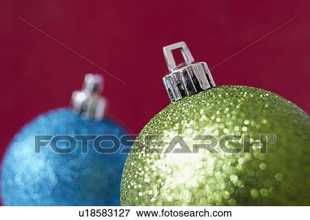 Close up of shiny Christmas decorations on red background View Large Photo Image Stock Photo - Close up of shiny Christmas decorations on red background. Fotosearch