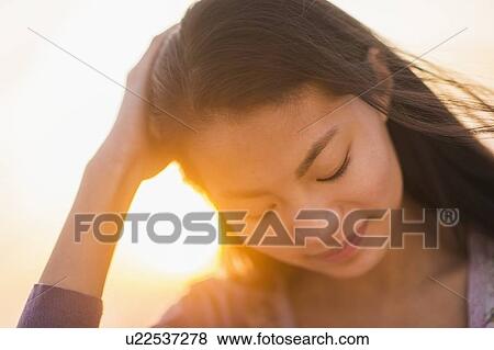 Close-up of smiling teenage girl ( 16-17 years) with sunset in background View Large Photo Image Stock Photo - Close-up of smiling teenage girl ( 16-17 years) with sunset in background. Fotosearch