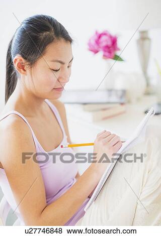 Close-up of teenage girl ( 16-17 years ) studying at home View Large Photo Image Stock Photo - Close-up of teenage girl ( 16-17 years ) studying at home. Fotosearch