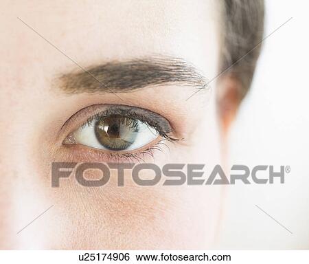 Stock Photograph - Close up of young woman's eye, studio shot. Fotosearch