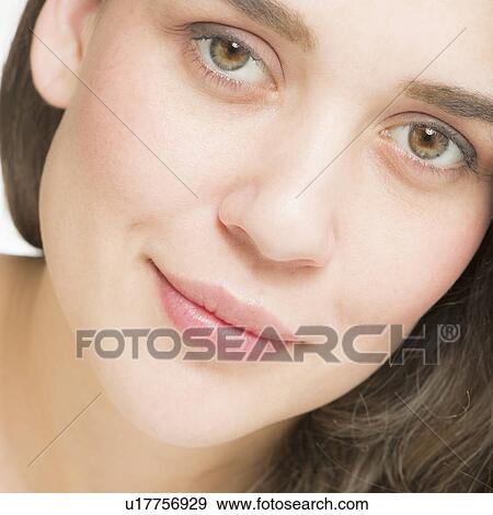 Stock Photo - Close up of young woman's face, studio shot. Fotosearch
