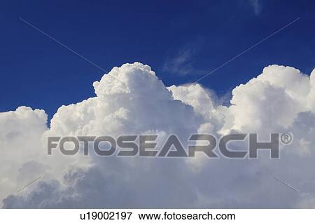 Stock Photo - Cloudscape against blue sky. Fotosearch