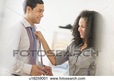 Stock Image - Couple buying tie. Fotosearch