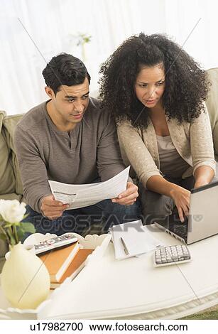 Stock Image - Couple doing home finances. Fotosearch