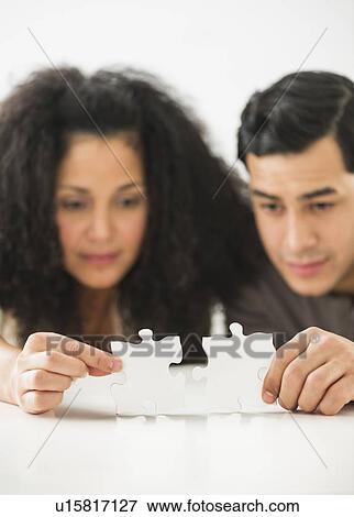 Couple matching jigsaw puzzle View Large Photo Image Stock Photo - Couple matching jigsaw puzzle. Fotosearch