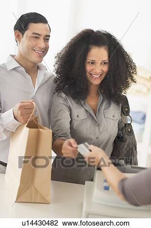 Couple shopping in clothes shop View Large Photo Image Stock Image - Couple shopping in clothes shop. Fotosearch