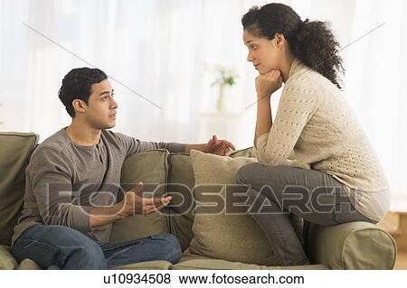 Couple talking on sofa View Large Photo Image Stock Photo - Couple talking on sofa. Fotosearch