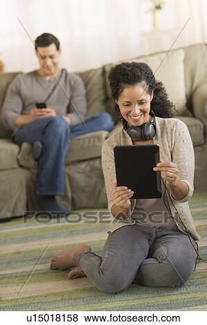 Couple using digital tablet and mobile phone View Large Photo Image Stock Photo - Couple using digital tablet and mobile phone. Fotosearch