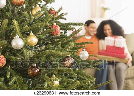 Stock Image - Couple with Christmas gifts. Fotosearch