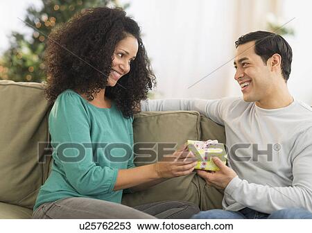Stock Image - Couple with Christmas gifts. Fotosearch