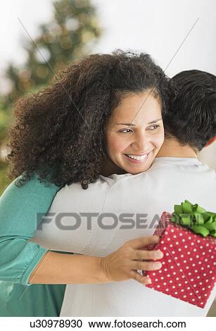 Stock Image - Couple with Christmas gifts. Fotosearch