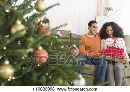 Couple with Christmas gifts View Large Photo Image Stock Photo - Couple with Christmas gifts. Fotosearch