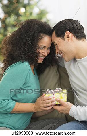 Stock Photo - Couple with Christmas gifts. Fotosearch