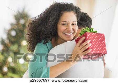 Stock Photo - Couple with Christmas gifts. Fotosearch