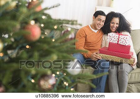 Stock Photograph - Couple with Christmas gifts. Fotosearch