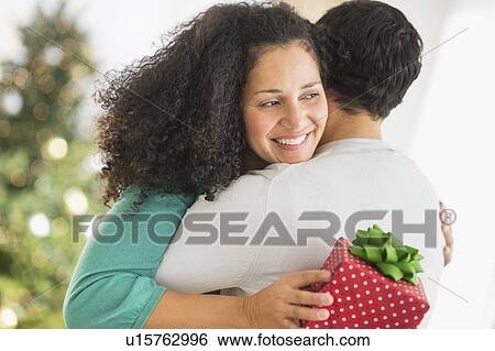 Couple with Christmas gifts View Large Photo Image Stock Photograph - Couple with Christmas gifts. Fotosearch