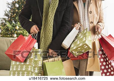 Stock Photography - Couple with Christmas shopping. Fotosearch