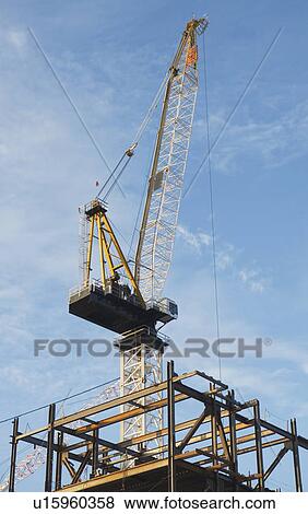 Crane at construction site View Large Photo Image Stock Photo - Crane at construction site. Fotosearch