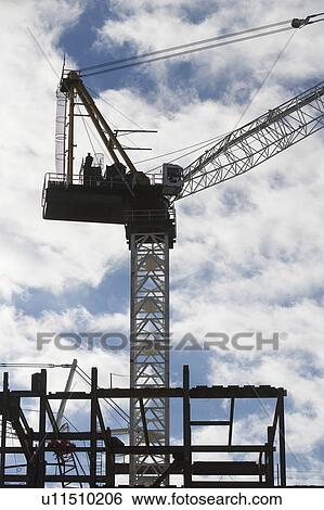 Stock Photograph - Crane at construction site. Fotosearch